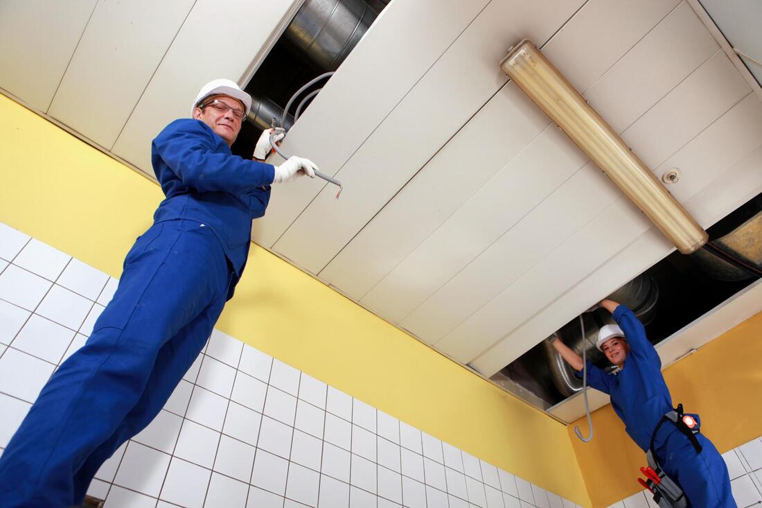 men installing air conditioning
